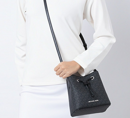 Cuero | SURI Small Logo Bucket Crossbody Black Signature Canvas